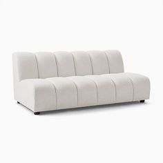 a white couch sitting on top of a white floor