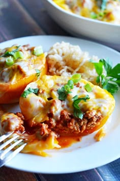 stuffed bell peppers with cheese and sauce on a white plate