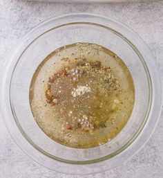 a glass bowl filled with food on top of a table