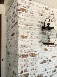 a brick wall with a lantern hanging on it