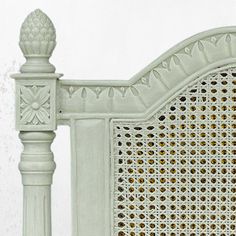 a white bed frame with intricate carvings on it