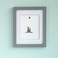 two small birds sitting on top of a white frame