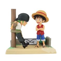 a figurine is standing next to a boy