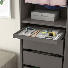 an open drawer with items on it in a room