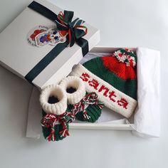 two knitted hats and mittens in a gift box