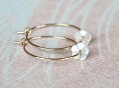 "Gold Filled Hoop Earrings, Tiny White Mother of Pearl Flower Hoop Earrings, Gold Hoop Earrings, Gold Earrings, Flower Hoops, Bridal Earrings, Gift for Her, Romantic Earrings, Feminine Earrings, Small Hoops, Dainty Earrings, MOP Earrings Adorable, feminine and lightweight 14k gold filled hoop earrings with the sweetest and tiniest carved white mother of pearl flowers. D E T A I L S: => Metal Type - 14k Gold Filled => Hoop size - Approx. 2 cm in diameter => Length - Approx 2 cm / 0.78\" Dainty Hoop Earrings With Flower Charm, Delicate Flower Charm Hoop Earrings, Minimalist Hypoallergenic Flower Earrings For Wedding, Delicate Hoop Earrings With Flower Charm, Dainty Hoop Flower Earrings Gift, Dainty Gold Small Hoop Flower Earrings, Delicate Hoop Jewelry With Flower Charm, Delicate Hoop Flower Earrings For Gifts, Delicate Flower Shaped Hoop Earrings As Gift