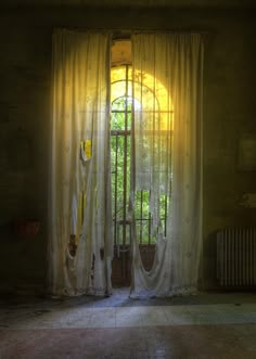 an open window with curtains in front of it