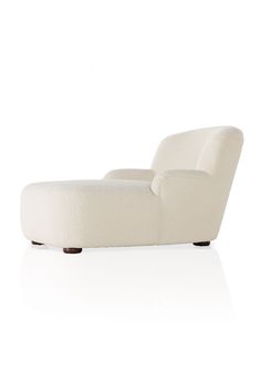 a white lounge chair sitting on top of a white floor