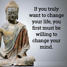 a buddha statue sitting on top of a white floor next to a quote that says if you truly want to change your life, you first must be wiling to change your mind