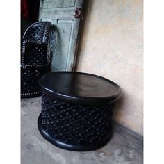 a black stool sitting next to a white door