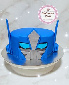 a blue and grey cake with an iron mask on top