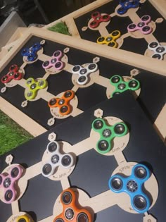 several different types of fidgets sitting on top of a black board with holes in them