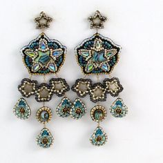 One Of A Kind Handcrafted Beaded Earrings In A Pentagon And Star Design. Bead Embroidery Featuring Glass Beads And Abalone Shell With Gold Chain And Dangles That Move With You. Colors Are Peacock Green, Metallic Blue, 24k Gold, Antique Matte Silver, And Matte Chocolate Brown. Post Style Earrings. Length: 4" Width: 1 1/4" Peacock Green, Couture Jewelry, Star Design, Metallic Blue, Seed Bead Earrings, Bead Embroidery, Abalone Shell, Style Earrings, Bead Earrings