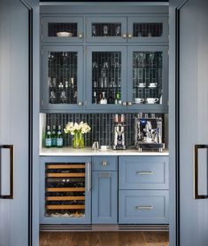 a kitchen with blue cabinets and glass doors