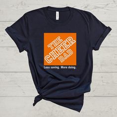 'The Cheer Dad-Less saving. More doing.' Tee! This shirt is a unisex fit. ---T-SHIRT FABRIC DETAILS--- 100% airlume combed and ringspun cotton Heather colors are 4.2 oz., 52% airlume combed and ringspun cotton, 48% polyester, 32 singles Heather Athletic is 90% airlume combed and ring-spun cotton, 10% polyester ---CARE INSTRUCTIONS--- Wash item inside out in cold water with like colors. Do not bleach. Do not dry clean. Do not iron directly over the design. ---DISCLAIMER--- Actual product colors m Cheer Tees Shirt Ideas, Cheer Dad Shirt Ideas, Cheer Dad Shirt, Cheer Dad Shirts, Allstar Cheer, Cheer Team Gifts, Sports Parent, Dad Shirts, Cheer Team