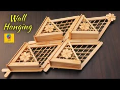 four wooden baskets with flowers on them sitting on top of a wood table next to the words wall hanging