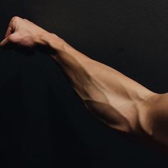 a man's arm with no shirt on, showing off his muscular arms and back