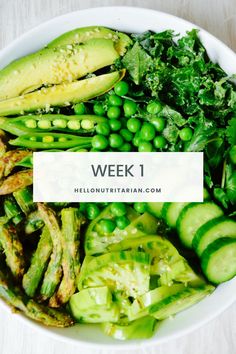 a white bowl filled with green vegetables on top of a table