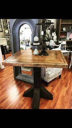 a wooden table sitting on top of a hard wood floor