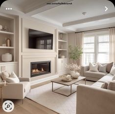 a living room filled with furniture and a flat screen tv mounted on the wall above a fire place