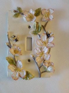 a light switch cover with flowers on it