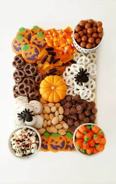 halloween treats are arranged in the shape of a letter made out of cookies and candy