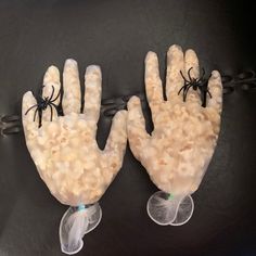 two fake hands made out of rice with spider webs on them