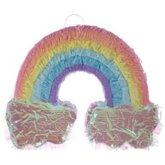 a rainbow shaped pinata hanging from a string on a white background with fringes