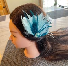 Fascinator Feather clip  Beautiful feather clip using different goose feathers and peacock fringe in teal blue and aqua colors. A beautiful metal pearl rhinestone embellishment is added in the center. It is attached to an alligator clip on the back. it measures approx 4" wide by 4" tall. Custom orders are accepted and can be made in any colors needed. Great for weddings, photo props, and other special occasions. This listing is for 1 piece but I can make as many as needed.  Combined shipping is available. feel free to ask any questions. Turnaround time is approx 1-3 days.  Note: I custom make all of my items, and I will be posting lots of listings for bridal, baby and special occasions. I had an Etsy store a few years ago and my items are high quality.  I'm not a new seller but due to fami Peacock Hair Accessory, Turquoise Hair Piece, Turquoise Hair Pin Wedding, Spring Adjustable Feather Hair Accessories, Indian Hair Accessories, Peacock Feather Hair Clip, Teal Hair, Feather Fascinators, Bridal Hair Clip