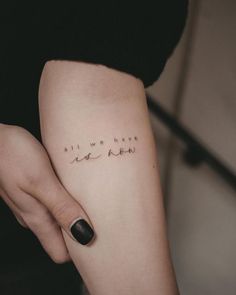 a woman's arm with writing on it that says, all we have is love