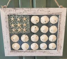 an american flag made out of sand dollars is hanging on a door with starfish