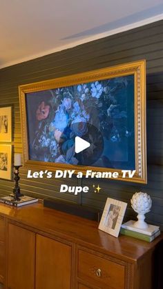 a tv that is mounted to the side of a wall next to a wooden dresser