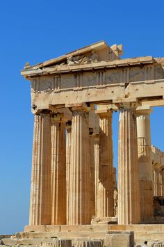 the ruins of an ancient greek temple against a blue sky