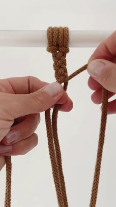 two hands are pulling the end of a rope