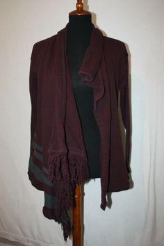 Welcome to Pim's clothing sales Very nice condition heavy weight knit sweater. Dark burgundy color with gray stripes at bottom front. Asymmetrical shawl collar goes to fringe. Button at inside top to wear as closed sweater also. Long sleeves. No pockets. Brand:  Cabi Material: 100% Cotton Size: XS tagged Shoulders: 19 Bust: 17 armpit to armpit Length: 25 back of collar to hem (Ask if you need more measurements)  Please Remember all Clothing Items may fit differently depending on Brand, Fit, Use Purple Bohemian Long Sleeve Sweater, Burgundy Cashmere Sweater, Burgundy Knit Long Sleeve Sweater, Casual Burgundy V-neck Sweater, Non-stretch V-neck Bohemian Cardigan, Shawl Cardigan, Open Cardigan, Burgundy Color, Shawl Collar