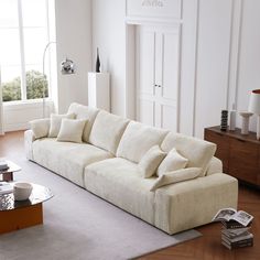 a living room with a couch, coffee table and two lamps on the side tables