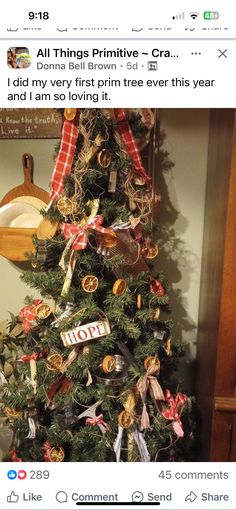 a small christmas tree decorated with ribbons and other items is displayed on the facebook page