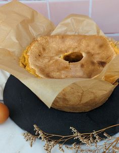 a cake sitting on top of a black plate next to an orange and brown egg