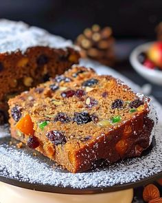 two slices of fruit and nut bread on a plate