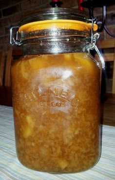 a glass jar filled with food sitting on top of a table