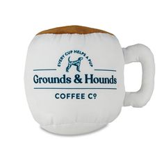 a white coffee cup holder with a brown handle and the words grounds & hounds on it