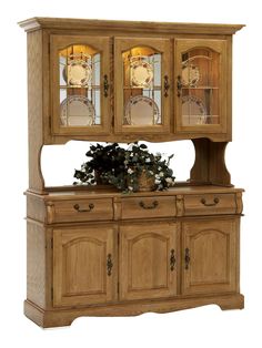 a wooden china cabinet with glass doors and two vases on the top, in front of a white background