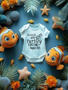 a baby bodysuit with an image of nemo and dory fish on it