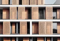 the facade of an apartment building with wooden shutters and balconies on each floor