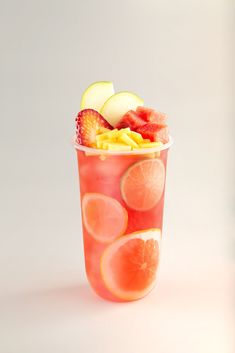 a cup filled with fruit sitting on top of a table