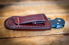 a leather case with a pocket knife on top of it