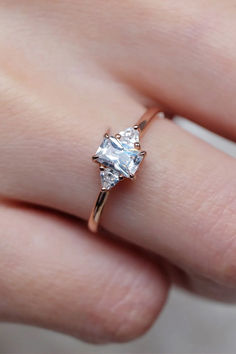 a woman's hand with a diamond ring on it