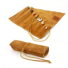 two pieces of brown suede material with leather handles and straps on each side, including an umbrella