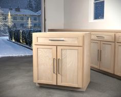 a kitchen area with wooden cabinets and a christmas tree outside the window in the background