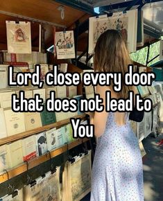 a woman standing in front of a book stand with the words lord, close every door that does not lead to you